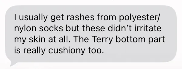 Text message review stating the socks did not cause skin irritation or rashes like typical polyester and nylon blends.
